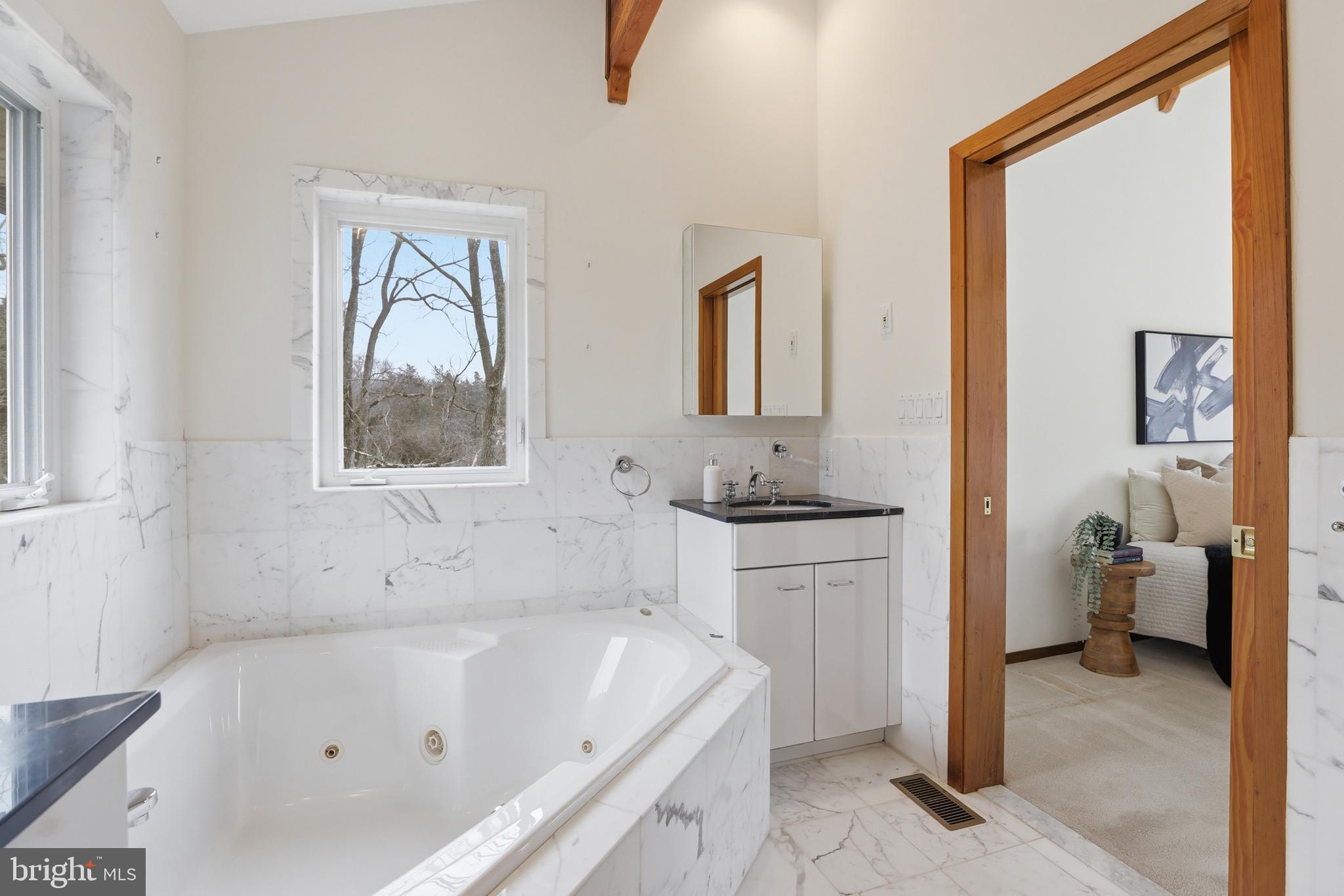 5931 Tyler Road Deale, MD 20751 - Photo 52 of 77 a bathroom with a tub sink and mirror