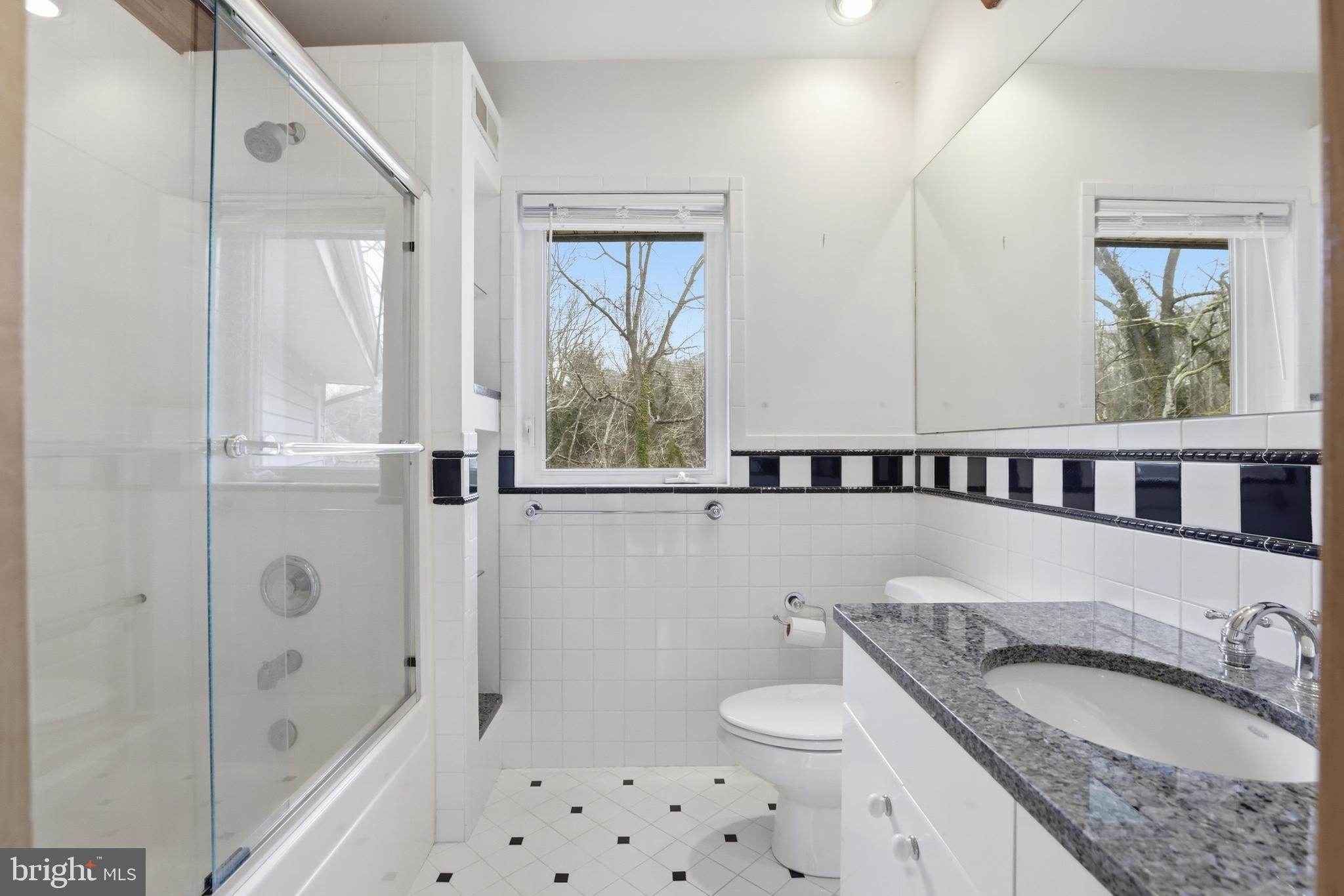 5931 Tyler Road Deale, MD 20751 - Photo 59 of 77 a bathroom with a granite countertop sink a toilet and shower