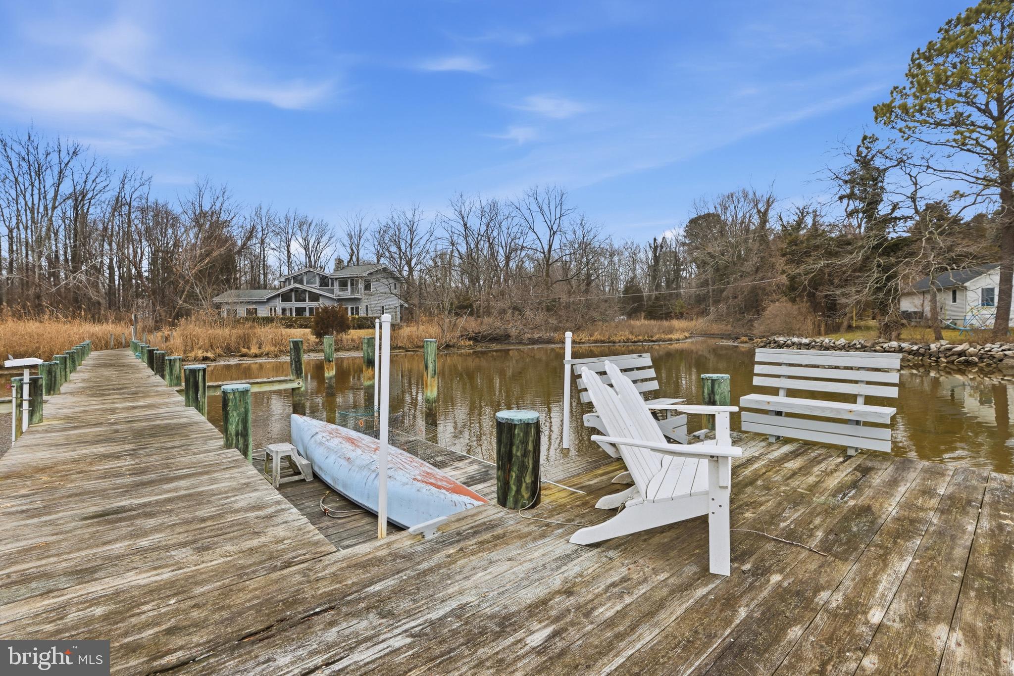 5931 Tyler Road Deale, MD 20751 - Photo 65 of 77 a view of a lake with a bench next to yard