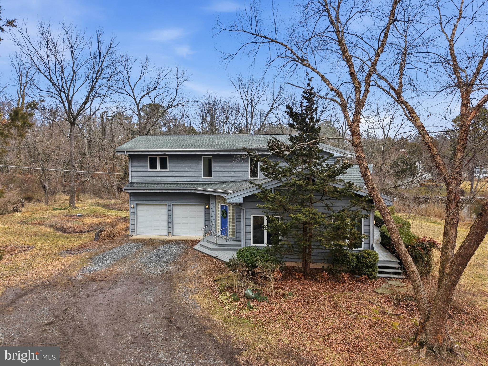 5931 Tyler Road Deale, MD 20751 - Photo 8 of 77 a white house that has a tree in front of it