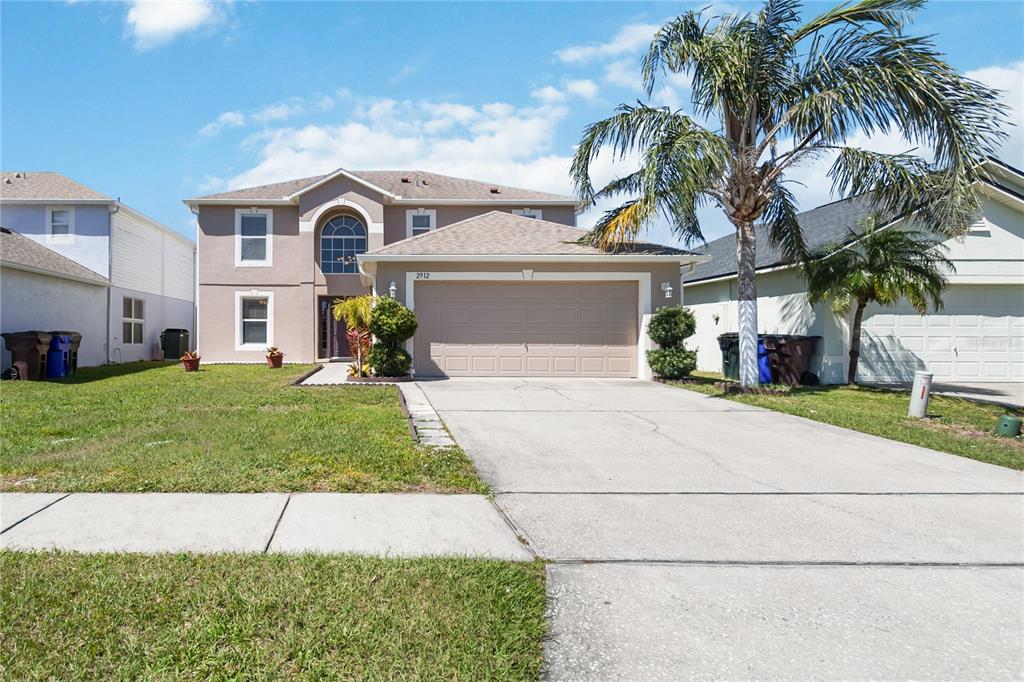 a front view of a house with a garden and plants