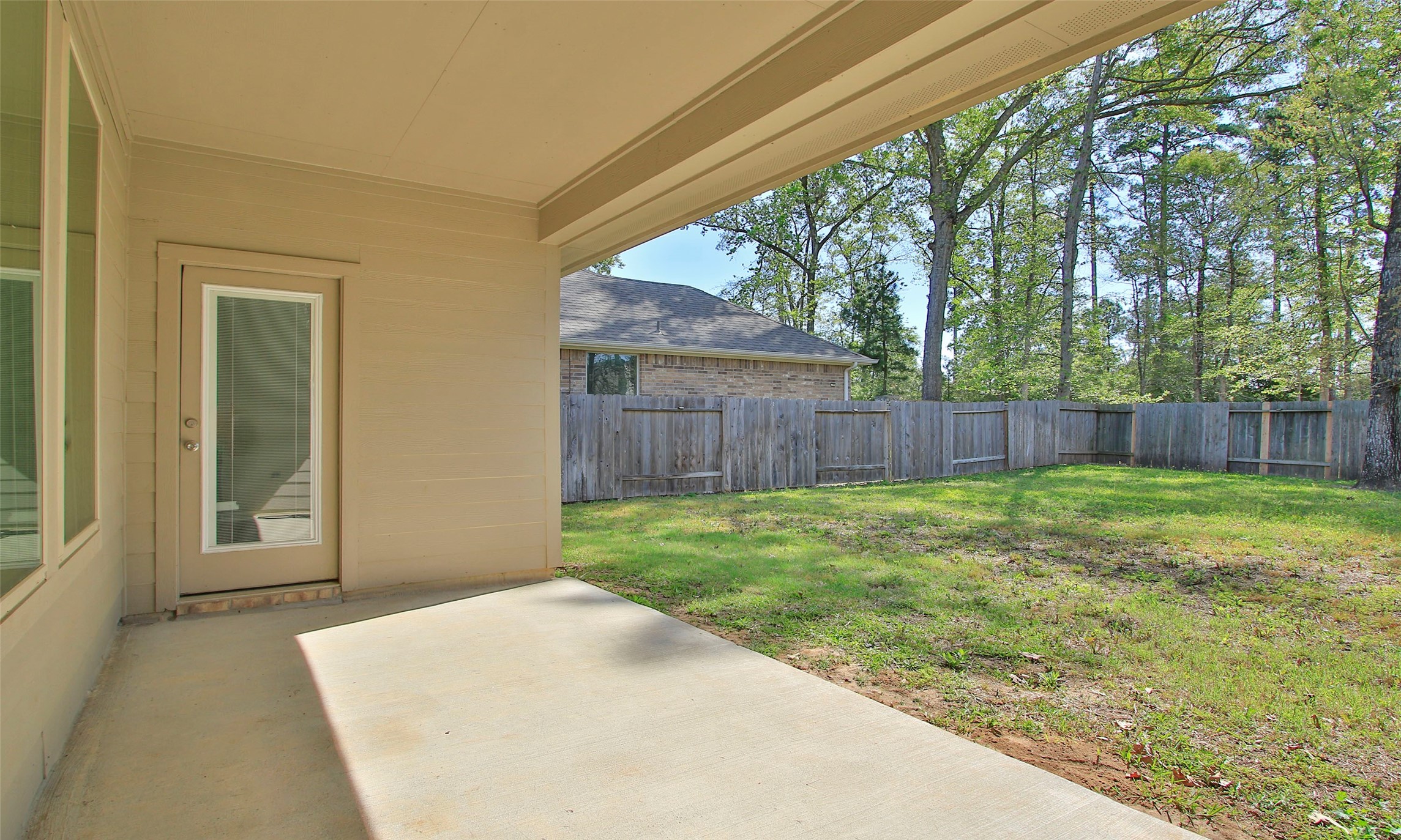 14120 Sand Ridge Court Conroe, TX 77384 - Photo 38 of 43 a view of a backyard with large trees and wooden fence