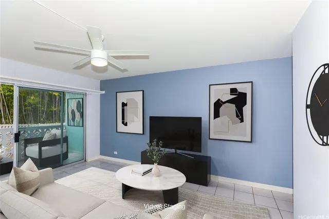 a living room with furniture a flat screen tv and a table