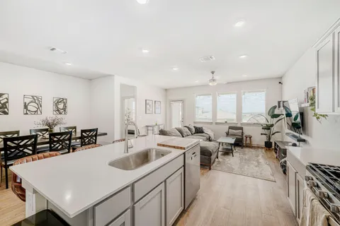 a view of a patio with couches and a table and chairs with wooden floor