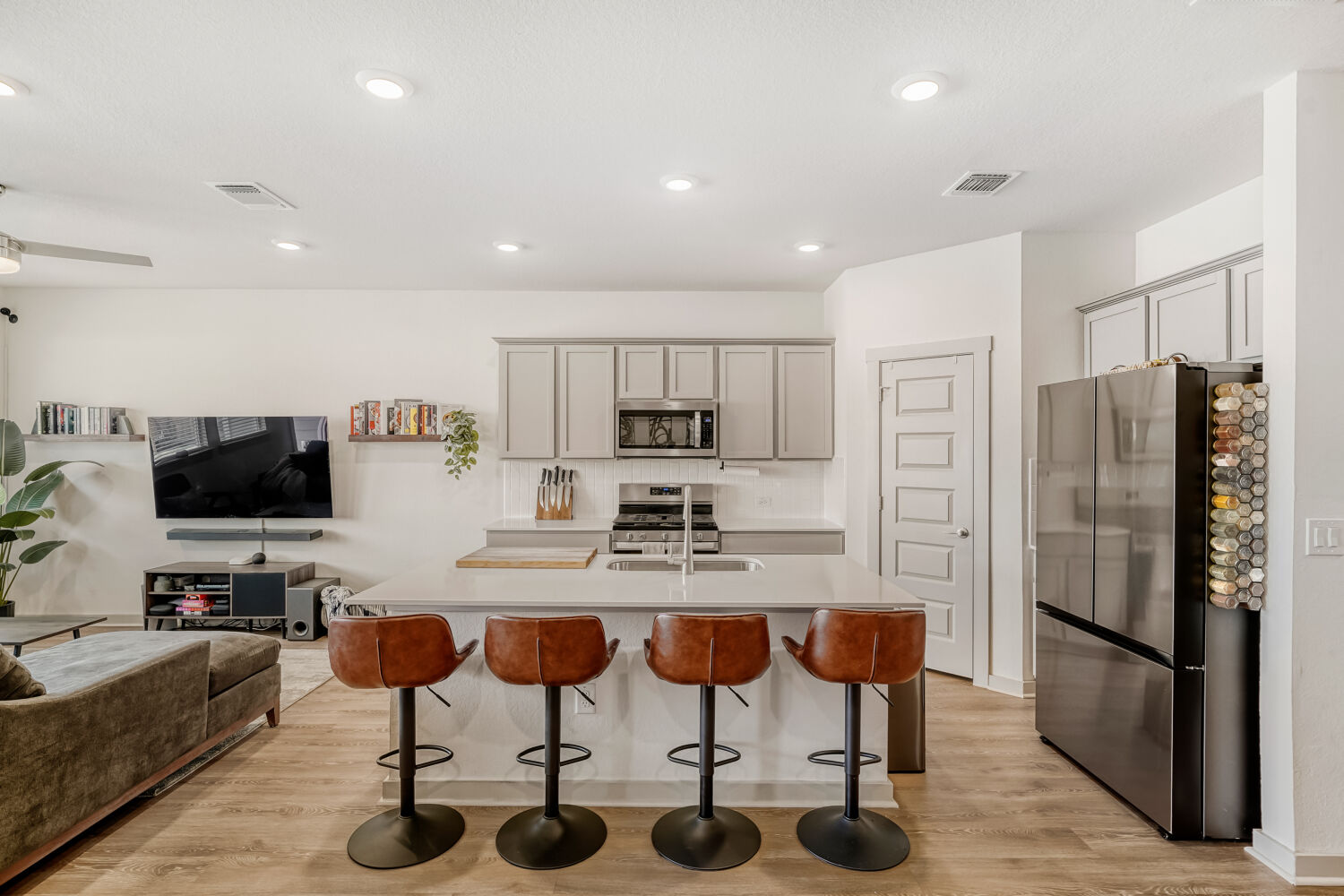 2308 Ranier Court Austin, TX 78754 - Photo 29 of 29 Kitchen featuring open floor plan, stainless steel appliances, light wood-type flooring, a center island with sink, and recessed lighting