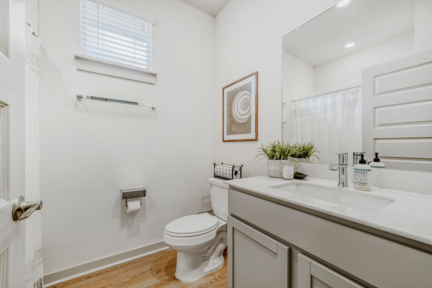 2308 Ranier Court Austin, TX 78754 - Photo 21 of 29 Bathroom with vanity, curtained shower, and light wood-style floors