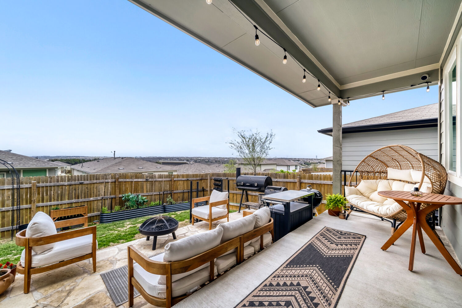 2308 Ranier Court Austin, TX 78754 - Photo 23 of 29 Fenced backyard with an outdoor living space with a fire pit, a patio, and a grill