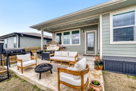 a view of a house with backyard porch and sitting area
