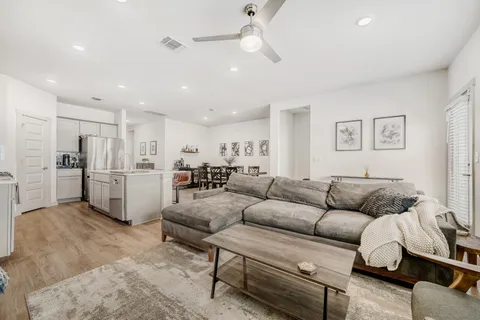 a living room with furniture and kitchen view