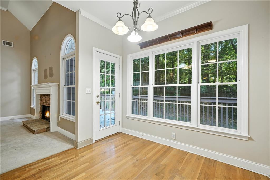 6745 Fairfield Trace Suwanee, GA 30024 - Photo 11 of 37 a view of an empty room with a window and wooden floor