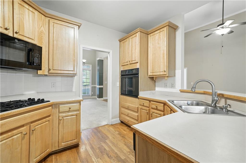 6745 Fairfield Trace Suwanee, GA 30024 - Photo 13 of 37 a kitchen with stainless steel appliances granite countertop a sink and a stove
