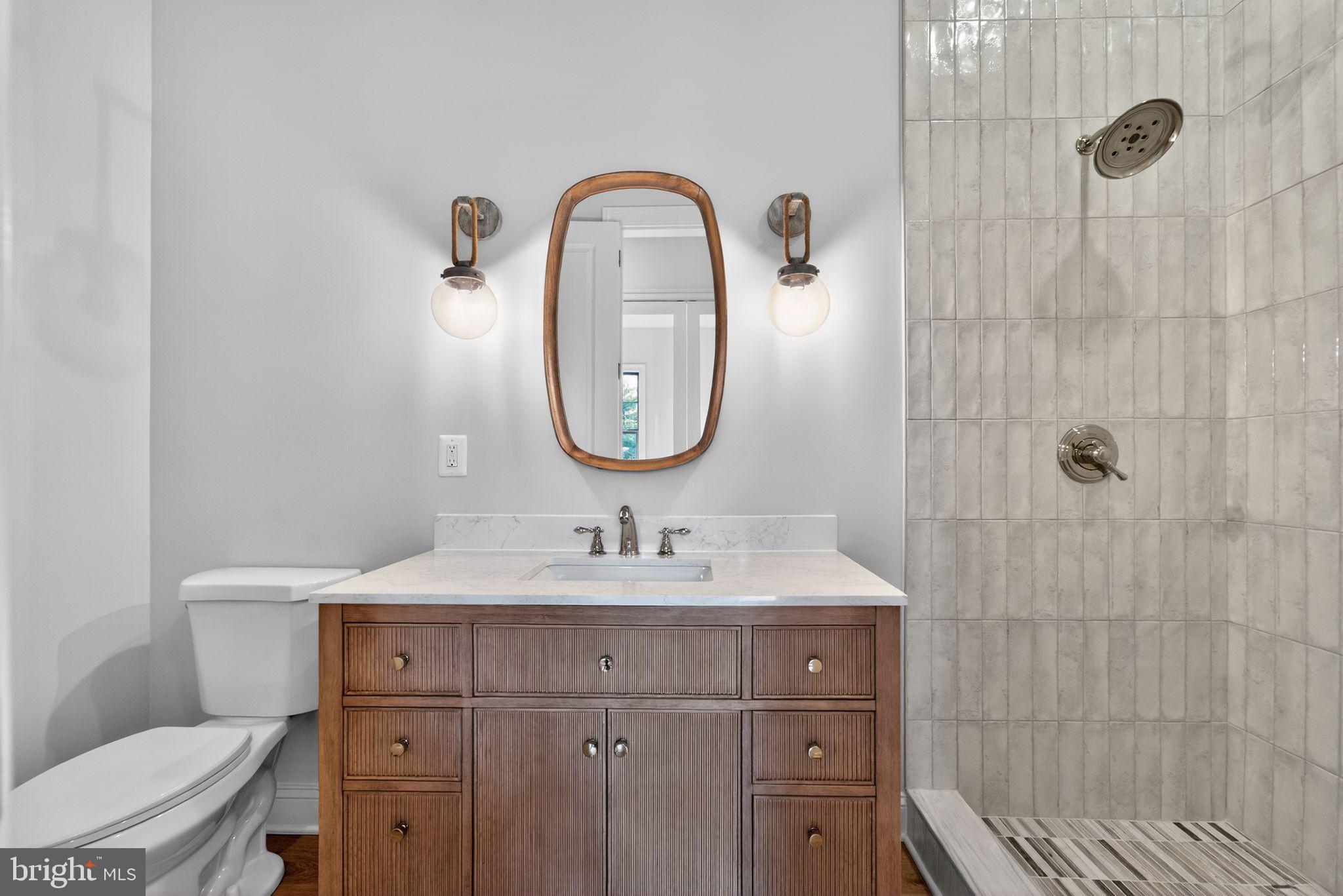 626 A Old County Road Severna Park, MD 21146 - Photo 16 of 52 a bathroom with a sink a toilet and a mirror