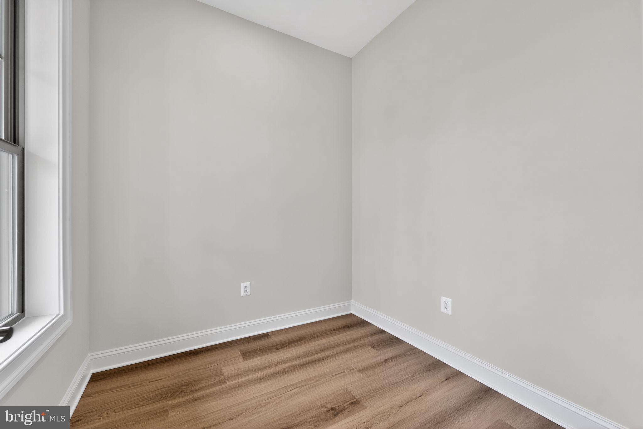 626 A Old County Road Severna Park, MD 21146 - Photo 17 of 52 a view of an empty room with wooden floor and a window
