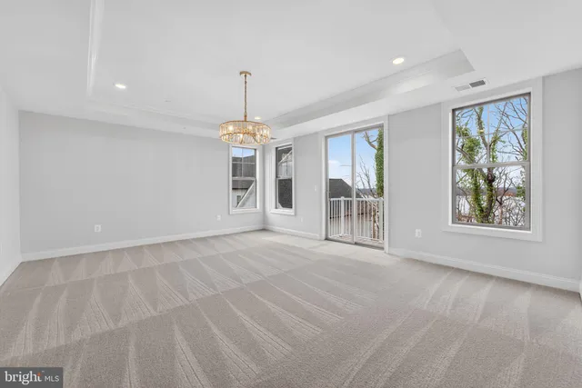 a view of an empty room with a chandelier