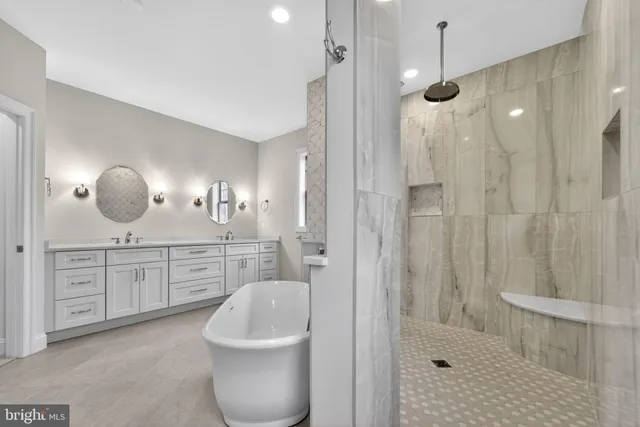 a bathroom with double vanity sinks and a mirror