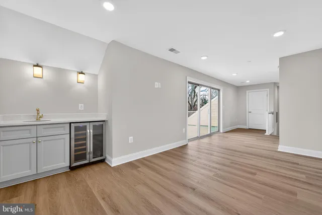 a bathroom with a toilet a sink a mirror a bathtub and vanity