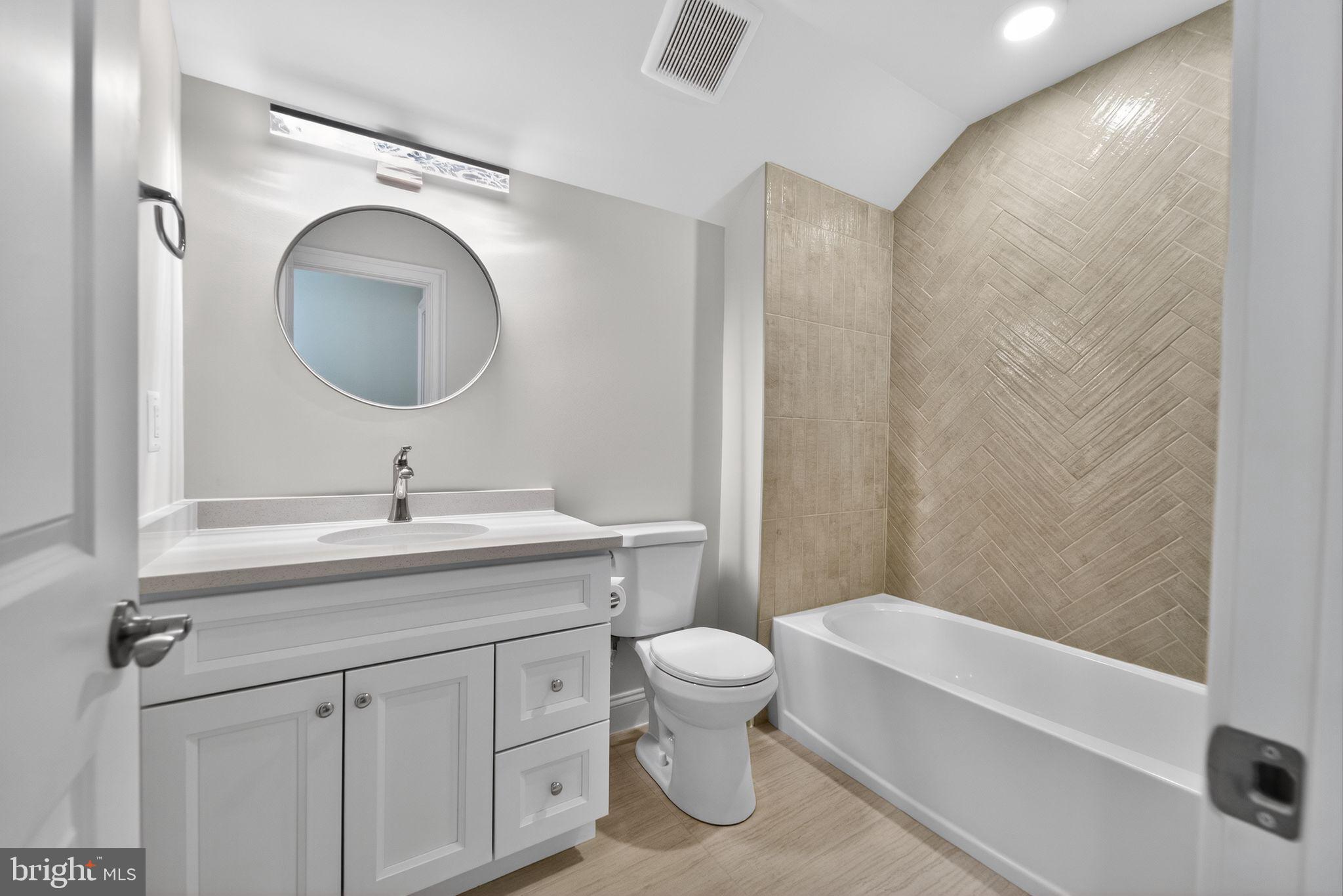 626 A Old County Road Severna Park, MD 21146 - Photo 41 of 52 a bathroom with a toilet a sink a mirror a bathtub and vanity