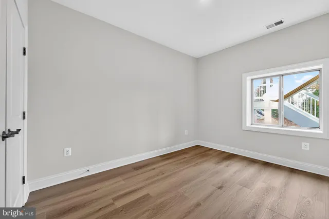 a view of a room with wooden floor