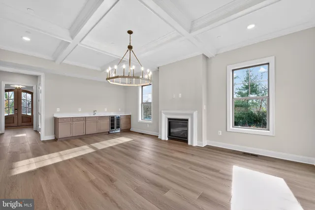 a view of a livingroom with wooden floor a fireplace and windows
