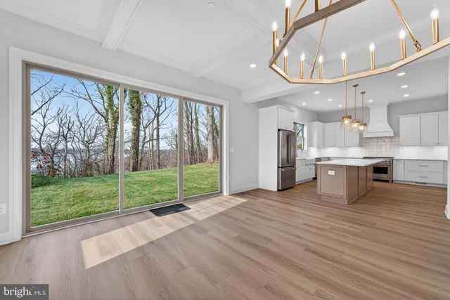a view of a living room and floor to ceiling windows