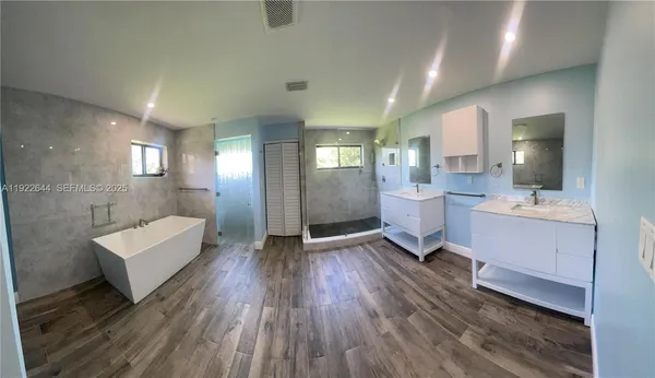a white bath tub sitting in a bathroom
