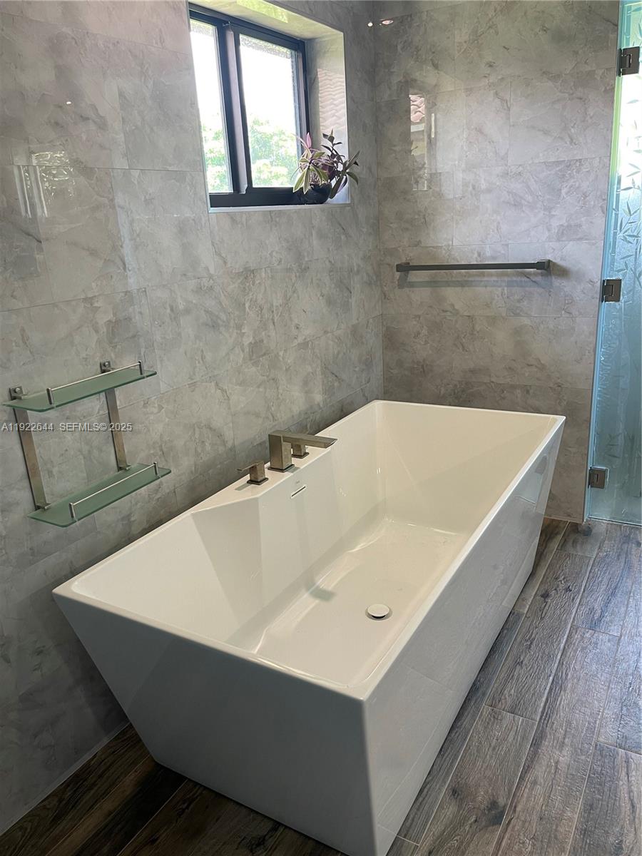 5425 Southwest 190th Avenue Southwest Ranches, FL 33332 - Photo 22 of 56 a white bath tub sitting in a bathroom