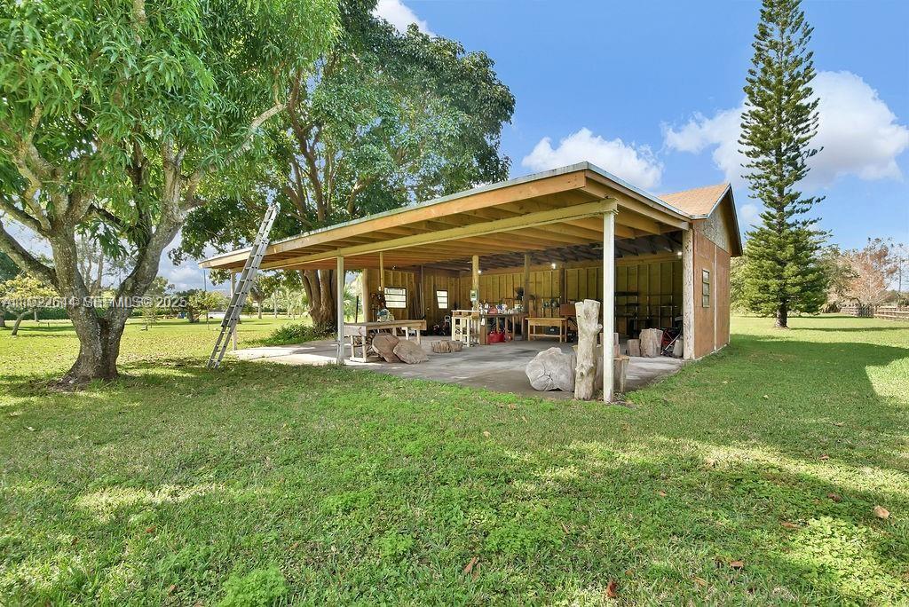 5425 Southwest 190th Avenue Southwest Ranches, FL 33332 - Photo 32 of 56 a view of a patio with table and chairs and a large tree