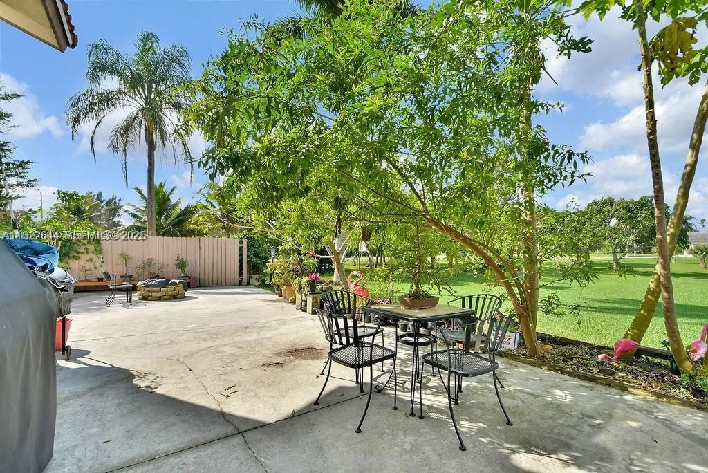 5425 Southwest 190th Avenue Southwest Ranches, FL 33332 - Photo 41 of 56 a patio with a table and chairs and potted plants