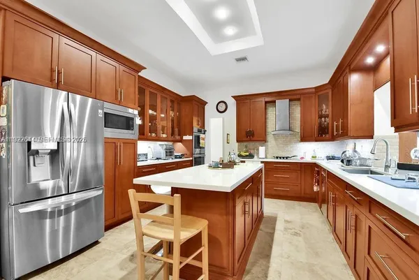a large kitchen with a table and chairs