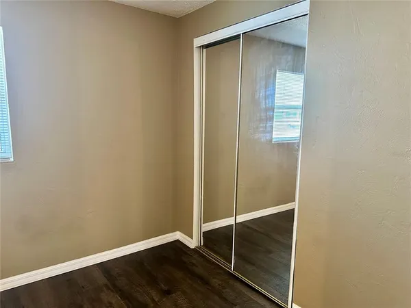 an empty room with wooden floor