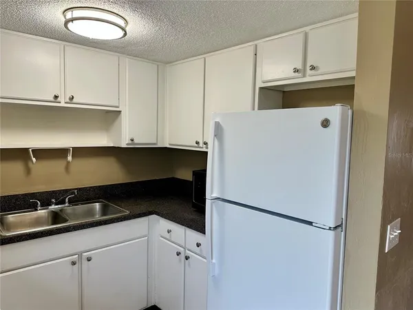 a white refrigerator freezer sitting inside of a kitchen