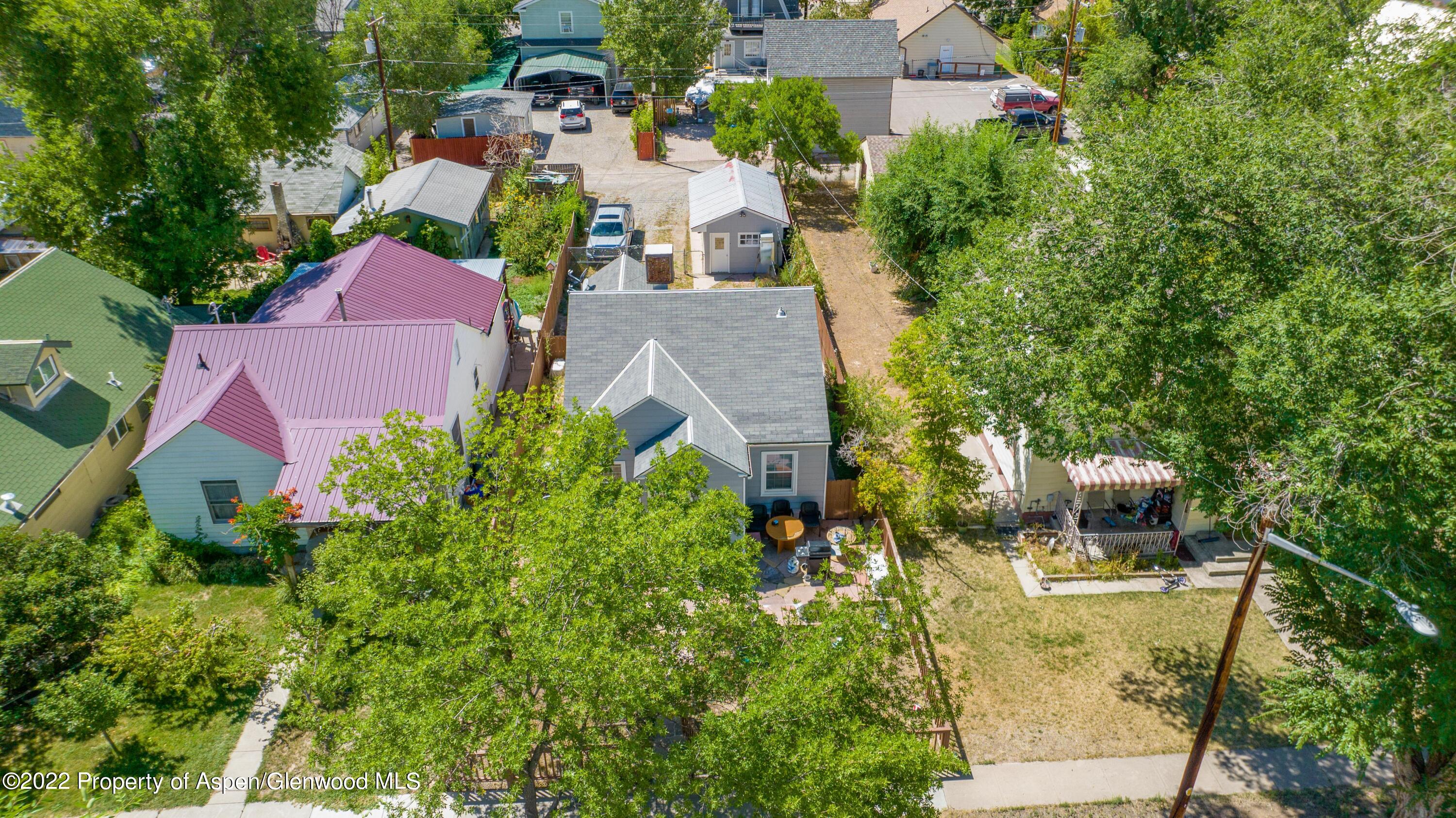 719 East Avenue Rifle, CO 81650 - Photo 1 of 18 an aerial view of a house with a yard and garden