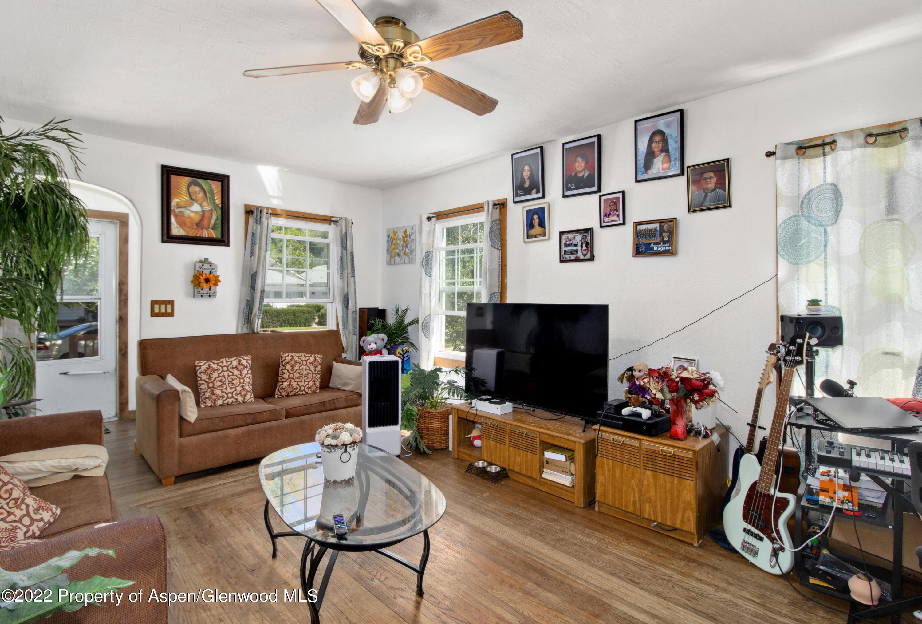 719 East Avenue Rifle, CO 81650 - Photo 4 of 18 a living room with furniture and a flat screen tv