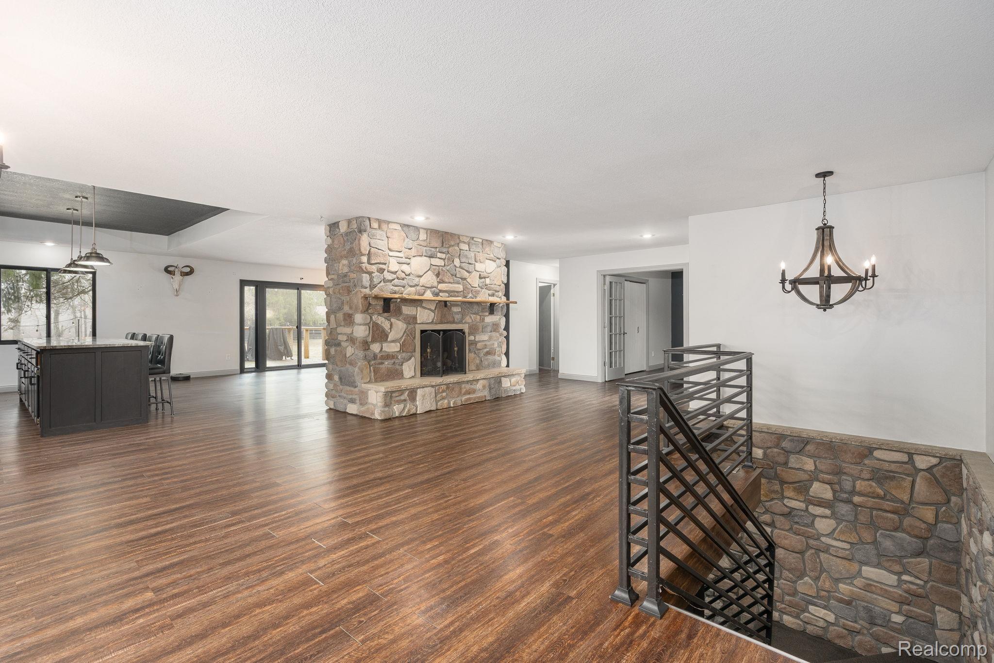 6803 Napoleon Road Jackson, MI 49201 - Photo 58 of 59 Open Floor Plan, Beautiful chandelier, hard wood-flooring, Custom Staircase
