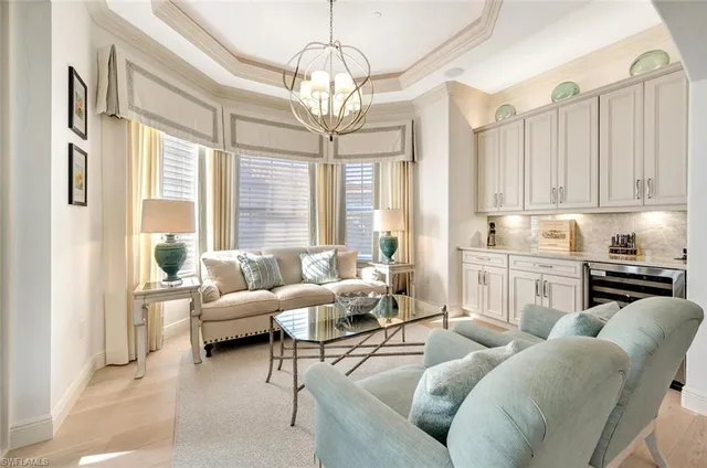 a living room with furniture and a chandelier