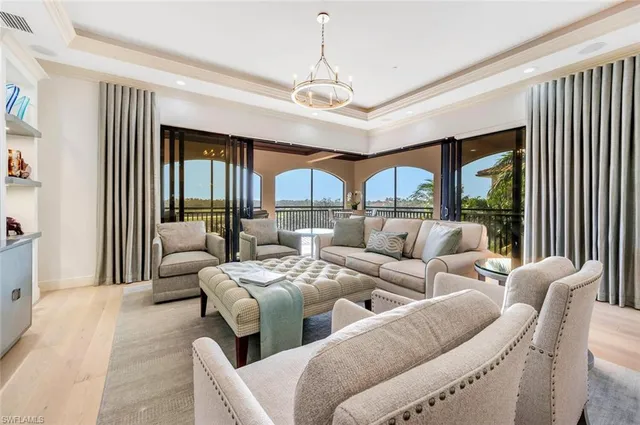 a dining room with furniture a chandelier and wooden floor