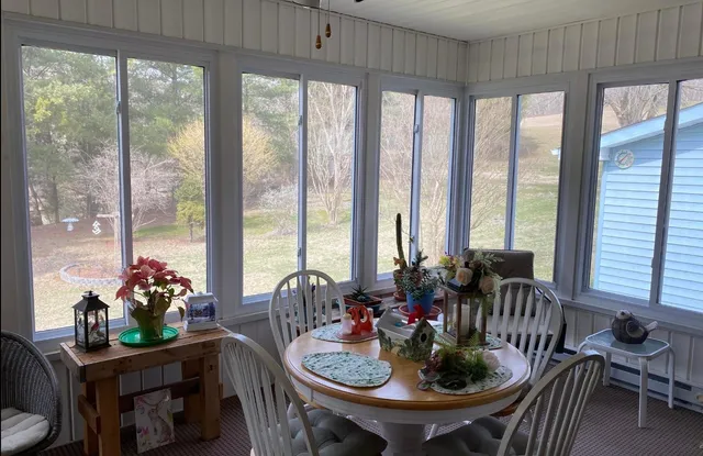 a view of a dining room with furniture window and outside view