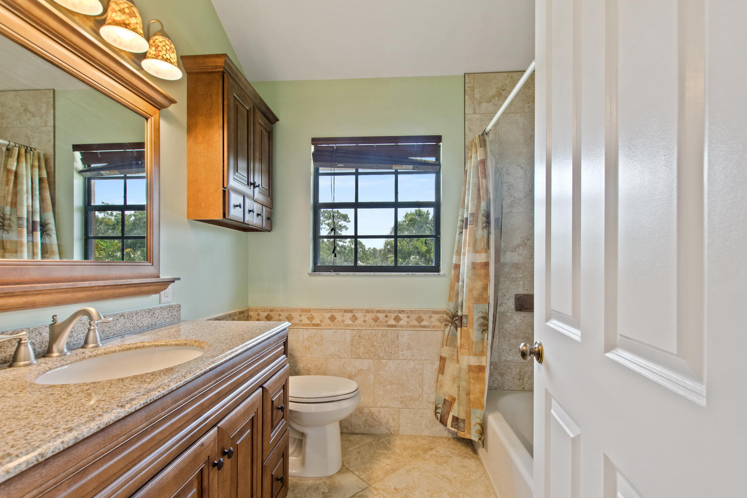 1350 C Road Loxahatchee Groves, FL 33470 - Photo 11 of 27 a bathroom with a granite countertop sink toilet and shower