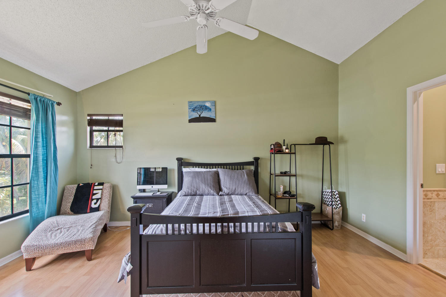 1350 C Road Loxahatchee Groves, FL 33470 - Photo 12 of 27 a bedroom with a bed table and a window