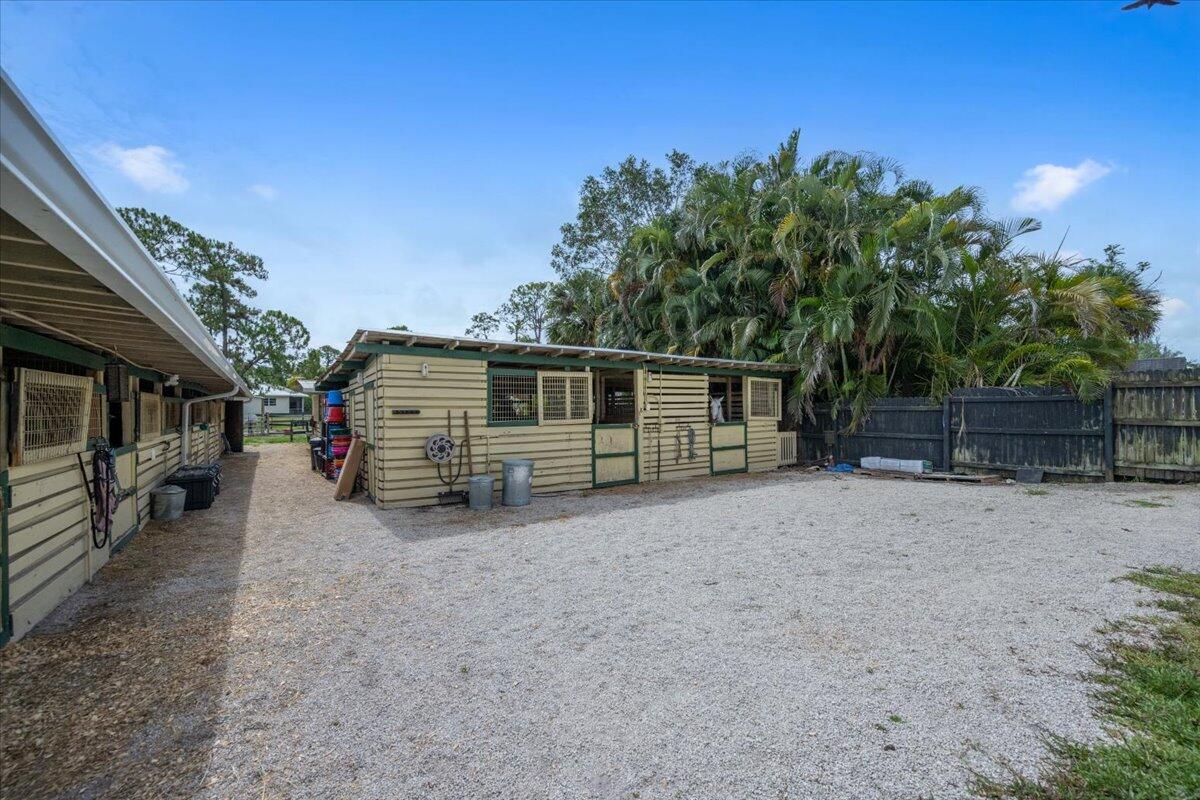 1350 C Road Loxahatchee Groves, FL 33470 - Photo 18 of 27 a view of a house with a yard