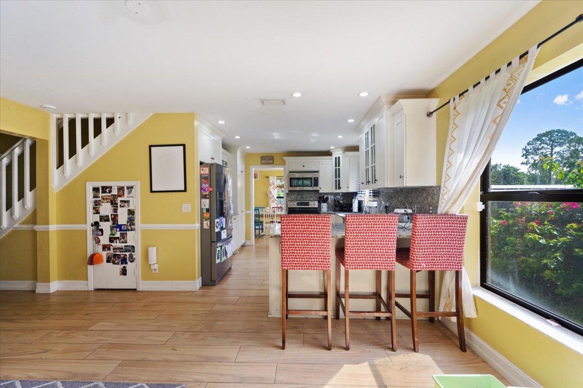 1350 C Road Loxahatchee Groves, FL 33470 - Photo 4 of 27 a dining room with furniture and a floor to ceiling window