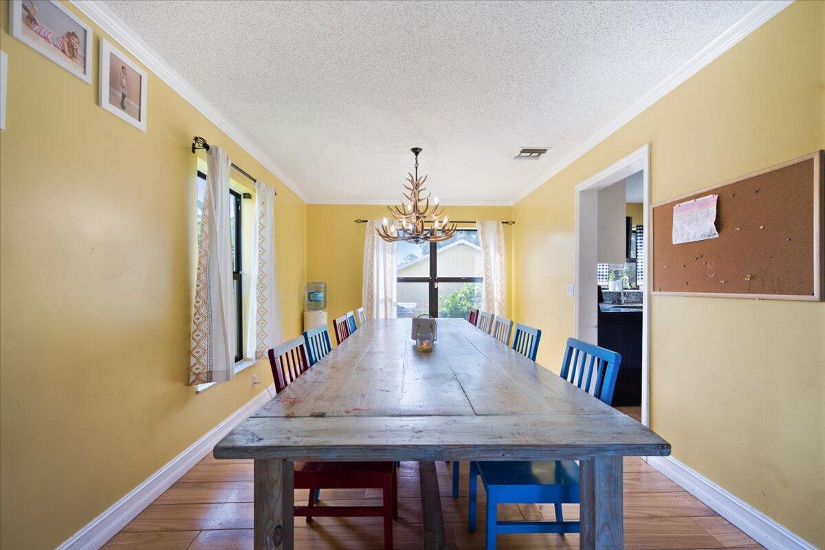 1350 C Road Loxahatchee Groves, FL 33470 - Photo 5 of 27 a view of a dining room with furniture and wooden floor