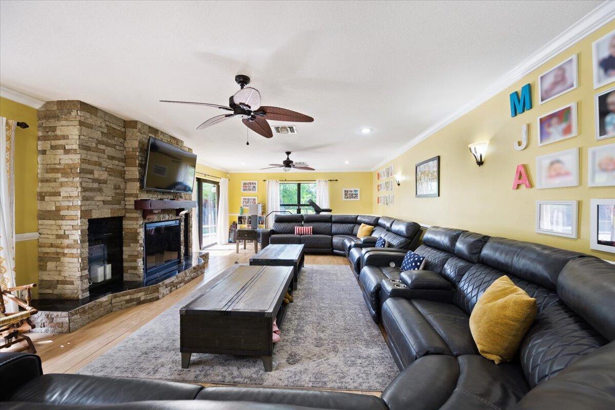 1350 C Road Loxahatchee Groves, FL 33470 - Photo 8 of 27 a living room with furniture and a fireplace