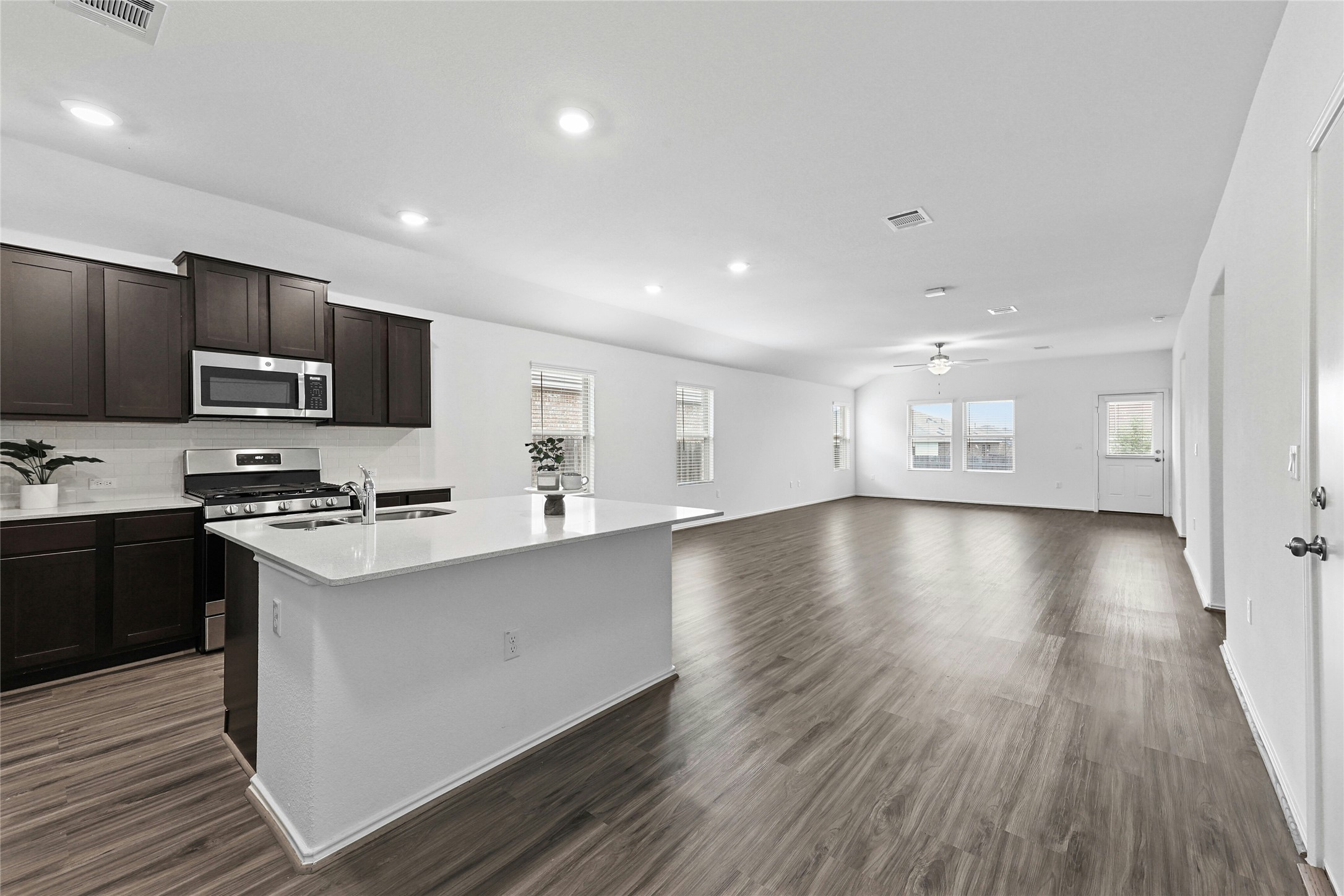 11813 Roscommon Trail Austin, TX 78754 - Photo 7 of 28 a large kitchen with cabinets wooden floor and stainless steel appliances