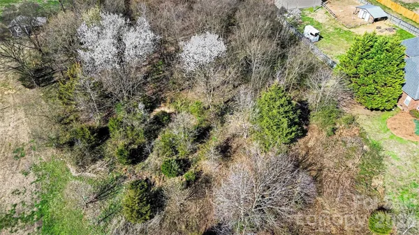 an aerial view of a house with a yard basket ball court and outdoor seating