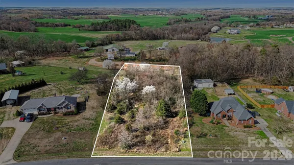 an aerial view of a house with a yard basket ball court and outdoor seating