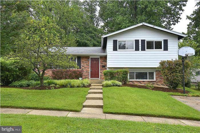 305 Irwin Street Silver Spring, MD 20901 - Photo 1 of 23 a front view of a house with a yard and garage