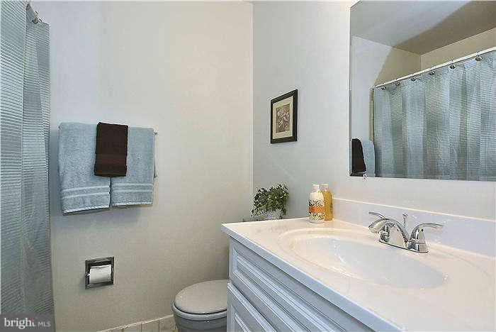 305 Irwin Street Silver Spring, MD 20901 - Photo 13 of 23 a bathroom with a granite countertop sink mirror vanity and toilet