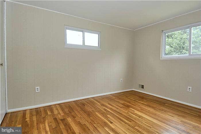 305 Irwin Street Silver Spring, MD 20901 - Photo 14 of 23 a view of a room with wooden floor and windows