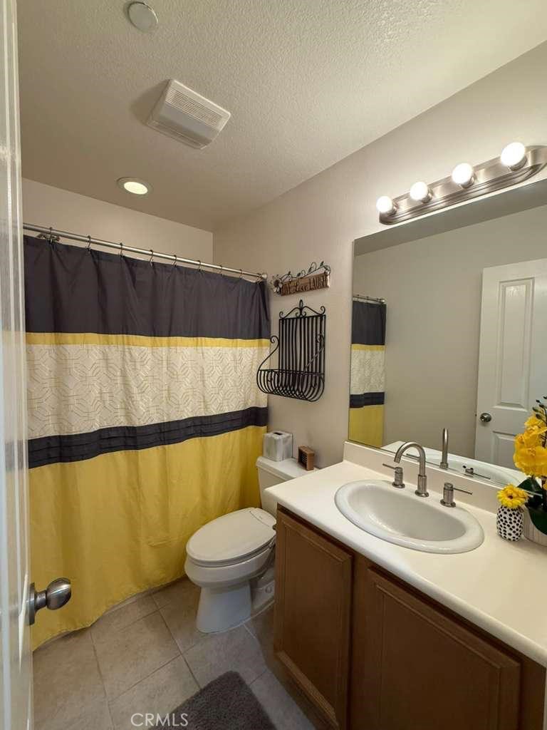 2931 Esperanza Way, Unit B Simi Valley, CA 93063 - Photo 19 of 49 a bathroom with a sink a toilet and a mirror